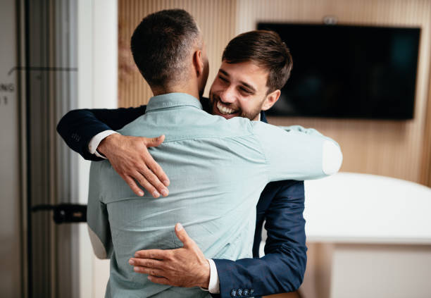 istock Diverse business people in office hugging after farewell 1441132675