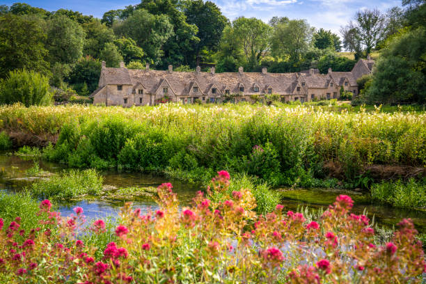 Bibury, Arlington Row in Cotswolds one of the most beautiful villages in England UK Bibury, Arlington Row in the England Cotswolds one of the most beautiful villages in the England countryside, UK ancient villages stock pictures, royalty-free photos & images