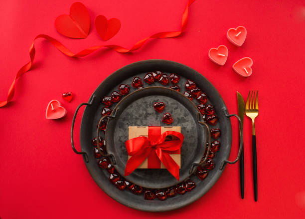 istock Banner. Romantic dinner. Vintage plates, festive table setting with a gift box on a red background. The concept of love. Valentine's Day. 1441134009