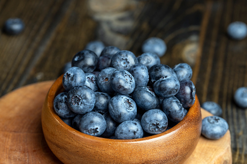 Ripe but long-lying blueberries on the table, harvested blueberries on the blackboard