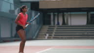 istock asian indian female tennis playing tennis in hardcourt tennis competition 1441137561