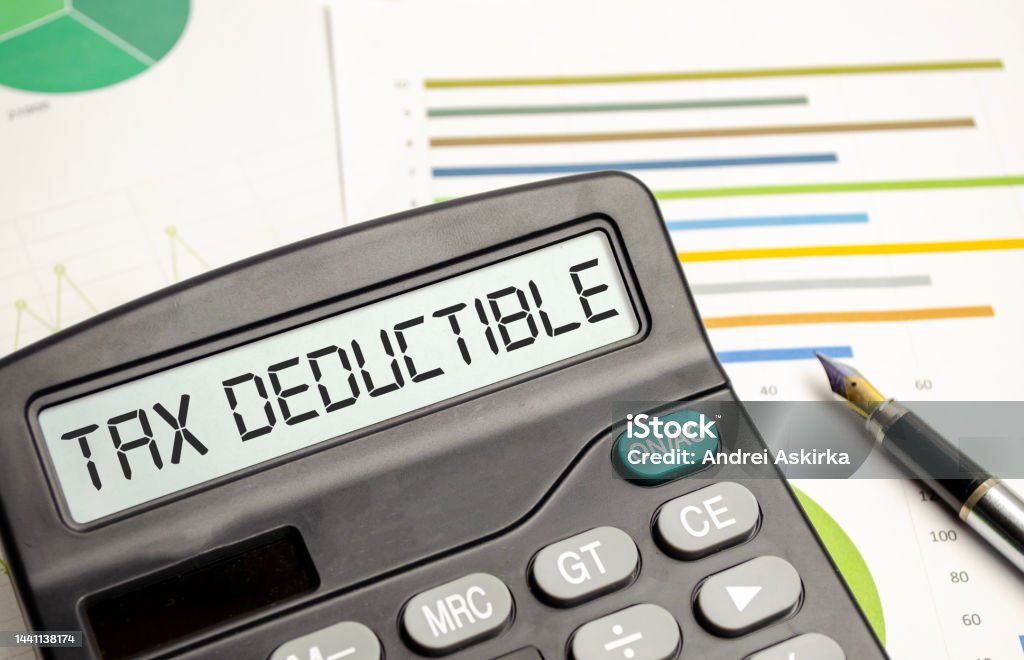 TAX DEDUCTIBLE word on calculator. Business and tax concept. Tax Stock Photo