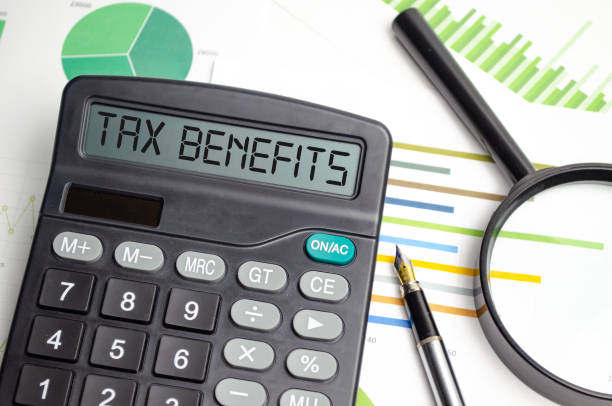 istock tax benefits on calculator display with pen and charts 1441138253
