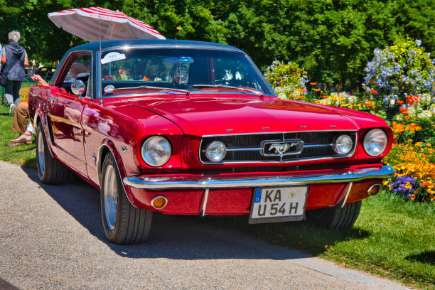 Baden-Baden, Germany - 10 July 2022: red Ford Mustang coupe first generation 1964 1973, oldtimer meeting in Kurpark.