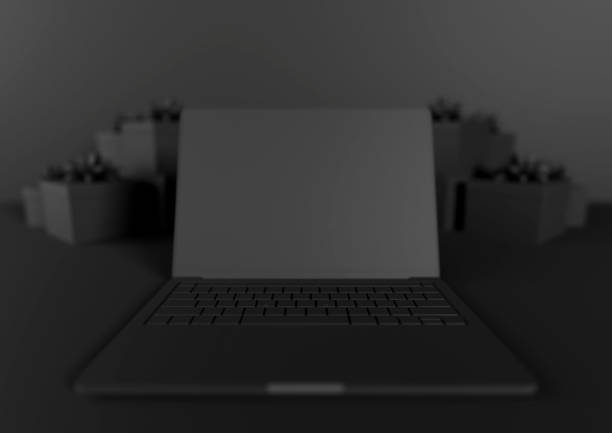 Black Friday / Cyber Monday laptop computer and presents with ribbons. Black background. Copy space. Online shopping.