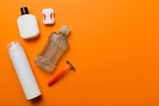 istock Composition with bath cosmetics on table. razor, toothpaste, soap, gel, toothbrush, mouthwash and other various accessories. Cosmetics for skin health. Bath Mockup for your logo 1441144077