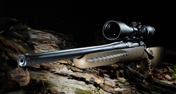 istock High powered riflescope on a rifle in a dark forest 1441147516