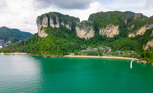 Ao Nang Tower, famous limestone rock near the Krabi town, Thailand. Aerial drone view to big rocks above turquoise sea. Exotic tourist destination.