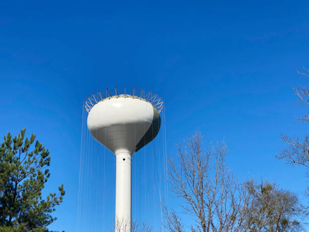 istock Newly constructed water tower being painted against blue sky 1441150825