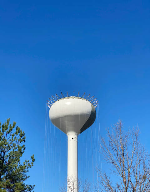 istock Newly constructed water tower being painted against blue sky 1441150849
