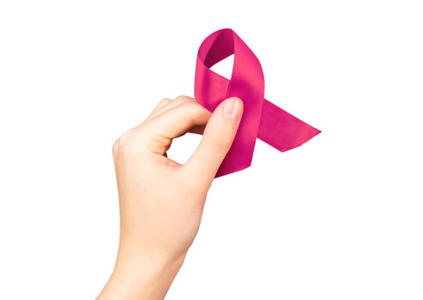istock Hand holding pink fabric ribbon isolated on white background 1441151501