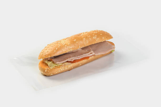 istock baguette with ham, tomatoes and herbs on a light background 1441151650
