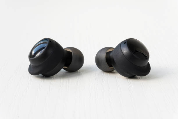 istock Two wireless headset closeup. Wireless headphones on a white background. 1441153183