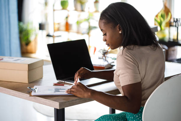 istock Woman checking project report while working at home 1441153315