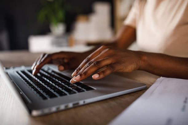 istock Black businesswoman typing data on laptop 1441153335
