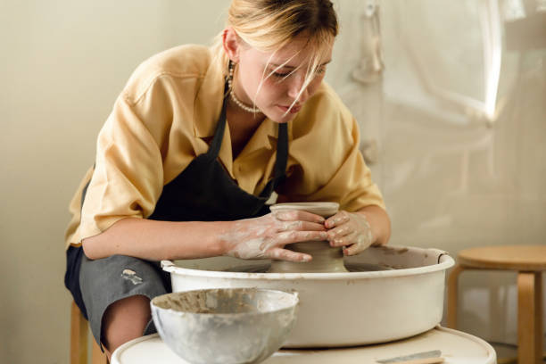 istock Young woman making pottery in her art studio 1441154669