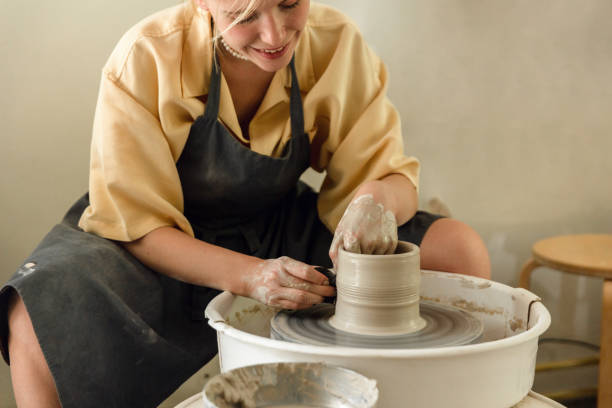 istock Young woman making pottery in her art studio 1441154681