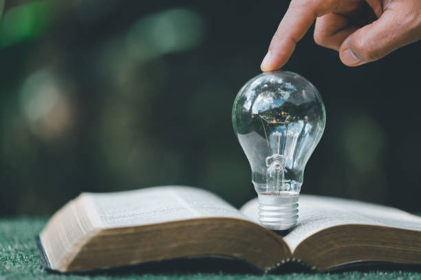istock Book or textbook with glowing light bulb. Self learning or education knowledge and business studying concept. Idea of learning or studying at home. technology, Create Imagination for Inspiration. 1441159149