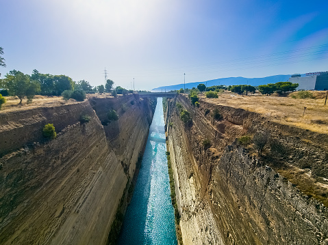 View from bridge of the Corinth Canal, an artificial canal in Greece, that connects the Gulf of Corinth in the Ionian Sea with the Saronic Gulf in the Aegean Sea.