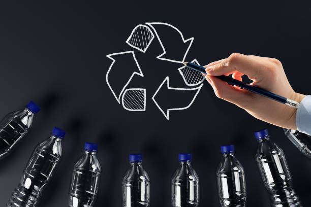 istock Plastic bottles with the recycling icon and painted recycling arrows. 1441160943
