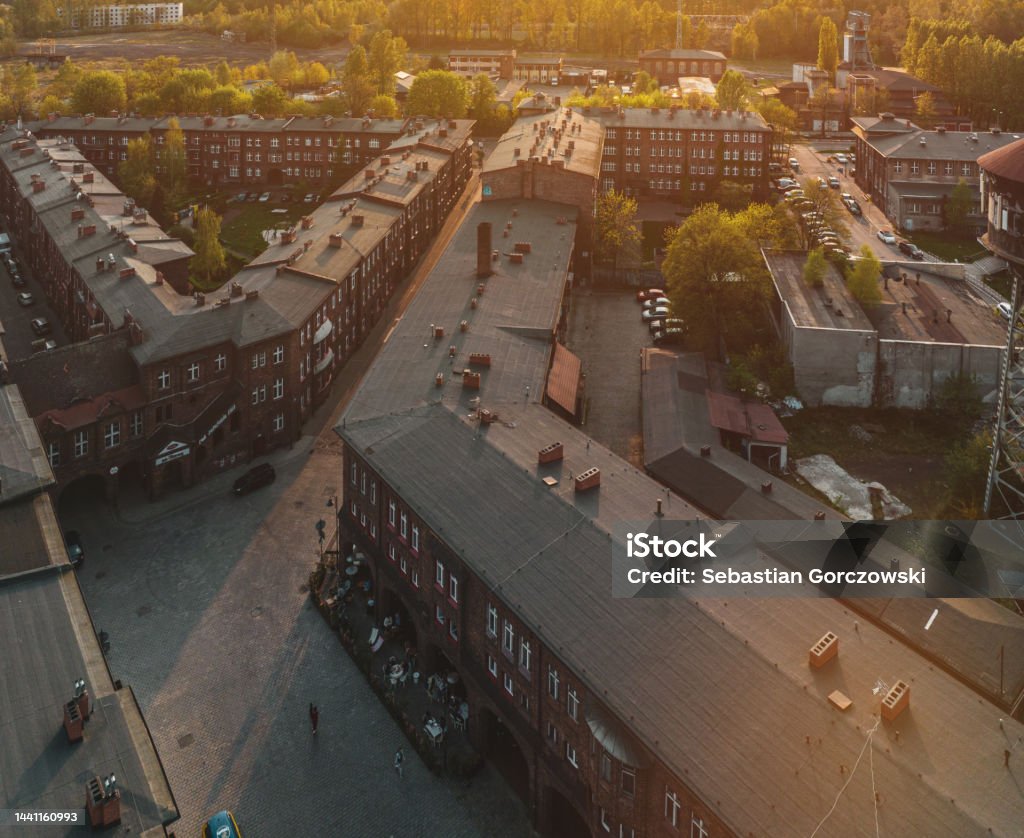 View of the church and the Nikiszowiec district in Katowice. Historic district in Katowice. The old mining town after renovation. View of Nikiszowiec from the drone. Photo from the air. Antique Stock Photo