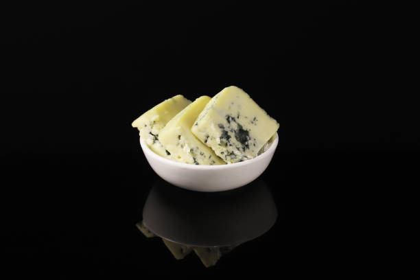 istock French cheese with blue mold in a white plate on a dark table with reflection. Close-up 1441161149