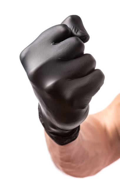 istock Fist punch in black rubber glove isolated on white background 1441163552