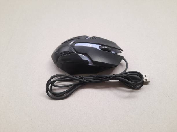 istock Gaming mouse in black top view on a brown background. 1441164821