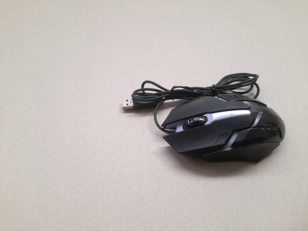 istock Gaming mouse in black top view on a brown background. 1441164839