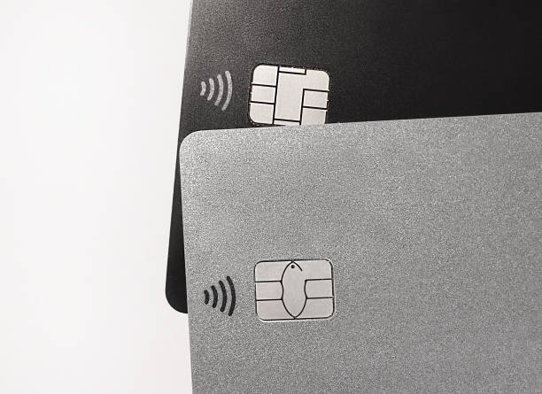 istock Bank cards with RFID chips. Radio Frequency IDentification tags. Contactless payment technology. RFID tag chip closeup. No name black and platinum bank card. Banking products and services. Radio waves 1441166239