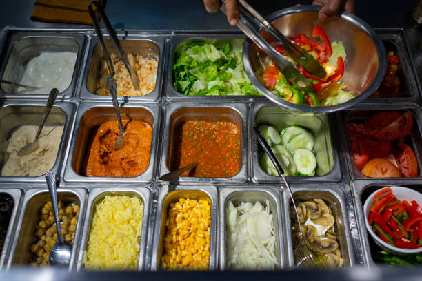 istock Chef preparing a stainless steel bowl with assorted salad with salad ingredients 1441166625