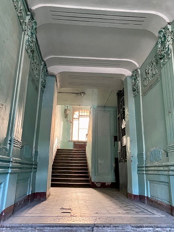 Typical old residential building hall with stairs