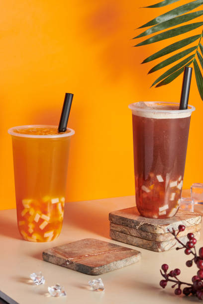 istock Plastic cups filled with fresh and tasty orange and grapefruit juices on the table 1441170558