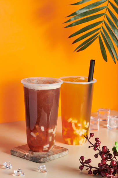 istock Plastic cups filled with fresh and tasty orange and grapefruit juices on the table 1441170567