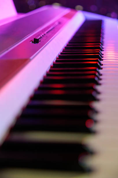 istock piano keyboard illuminated with pink light on stage ready to play 1441170609