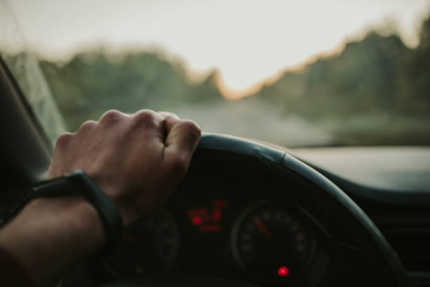 istock Closeup shot of a man holding the steering wheel while driving 1441170617