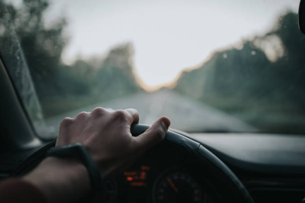 istock Closeup shot of a hand on a steering wheel while driving 1441170619