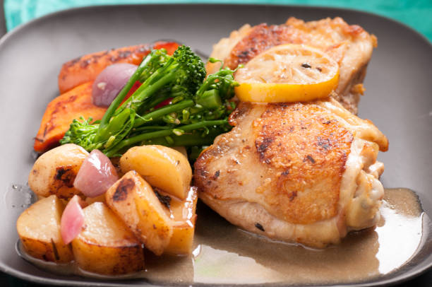 istock fried chicken thighs and vegetables 1441171832