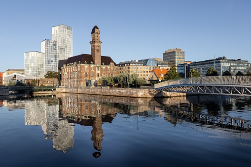 Malmoe, Sweden – September 02, 2021: The buildings of Malmoe city with the canal of Bagers Bro in foreground in the morning, Sweden