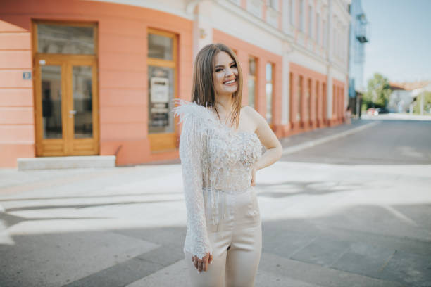 Caucasian female with a jumpsuit posing outdoors A Caucasian female with a jumpsuit posing outdoors jumpsuit stock pictures, royalty-free photos & images