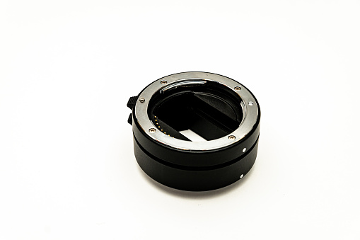 Black metal extension rings, for macro photography with normal lenses, isolated on a white background.