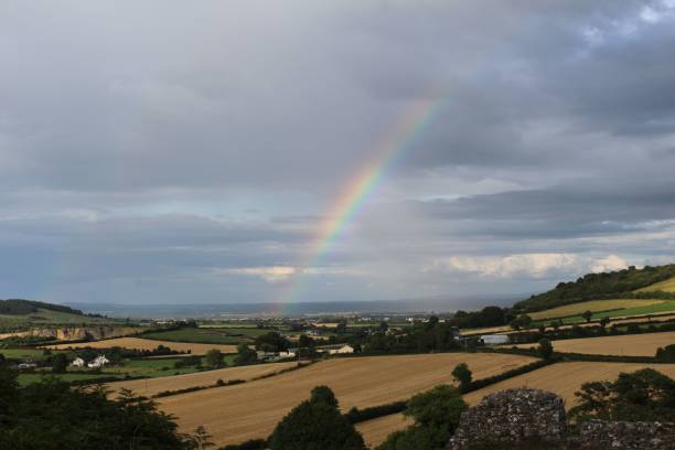 istock Cloudy day with a rainbow over a landscape 1441174275
