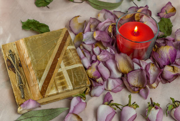 istock dried roses, candle and book 1441174696