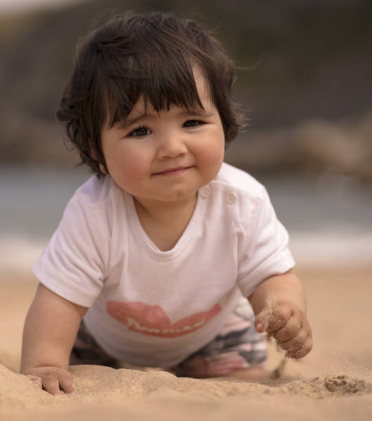 istock Cute Spanish baby on a sandy beach 1441175402