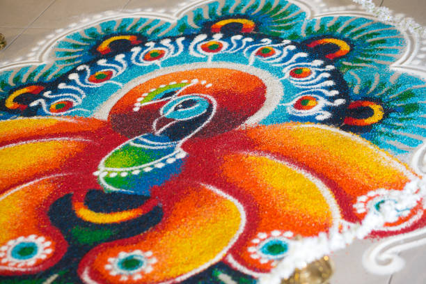 Beautiful Rangoli peaart design on a tiled floor A beautiful Rangoli peaart design on a tiled floor PEACOCK rangoli  stock pictures, royalty-free photos & images