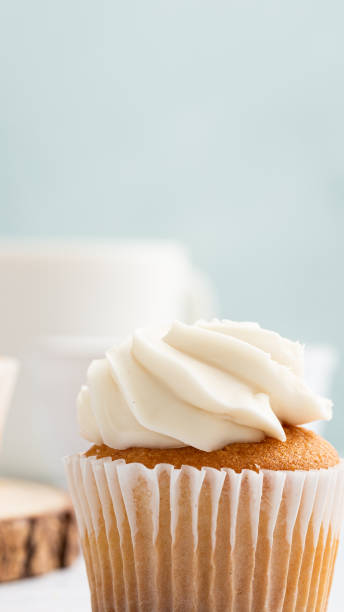 istock Vertical shot of appetizing cupcakes with cream on pastel blue backgroun 1441177150