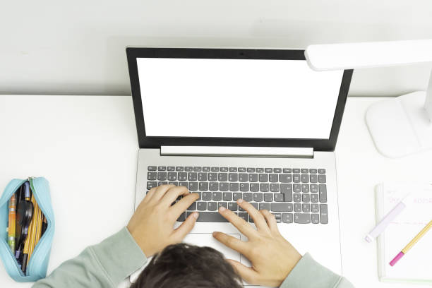 istock Young boy studying online on his laptop with space for text - concept of remote studying 1441177527