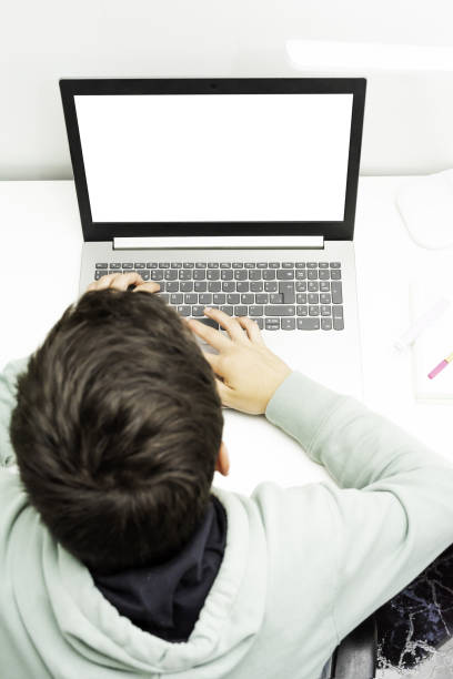 istock Young boy studying online on his laptop with space for text - concept of remote studying 1441177531