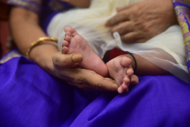 istock Baby feet in mother hands 1441177772