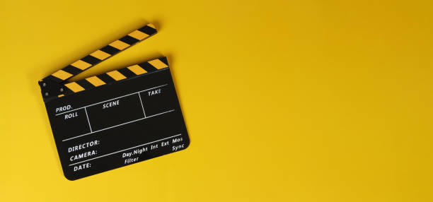 istock Clapper board or yellow movie slate on yellow background. 1441179367